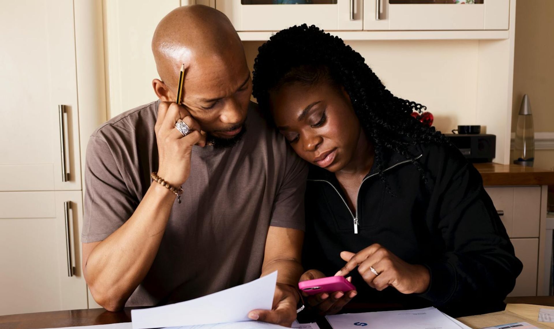 Couple looking at complex bills and paperwork