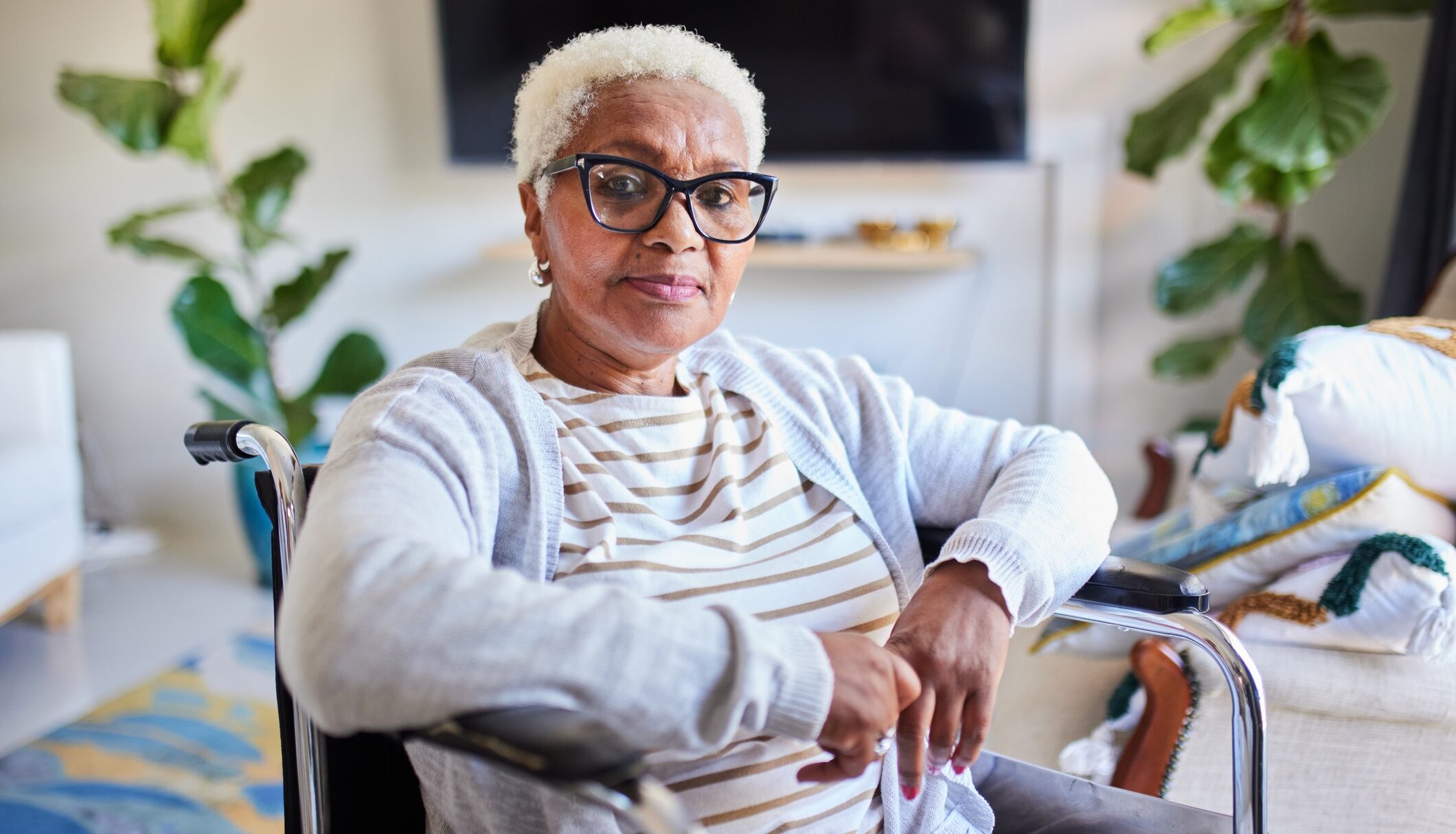 Thoughtful Senior in Wheelchair at Home