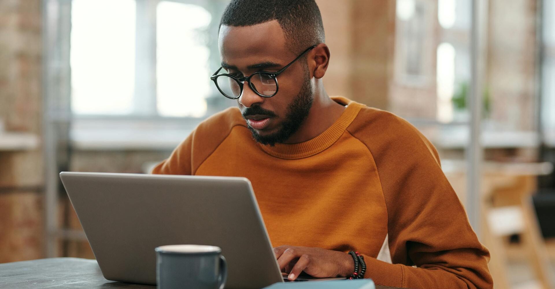 man looking up information on a laptop at work