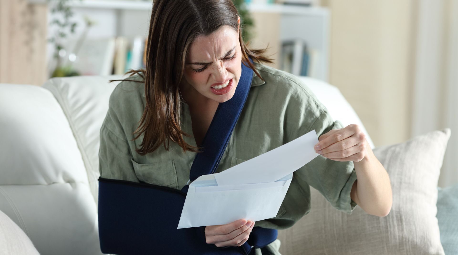 woman with broken arm receiving denial letter